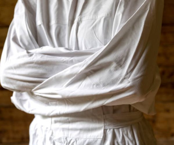 Woman with straitjacket, dark background