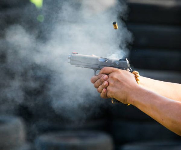 Shooting from a pistol. Reloading the gun. The man is aiming at the target