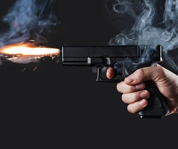 shot from a handgun with fire and smoke